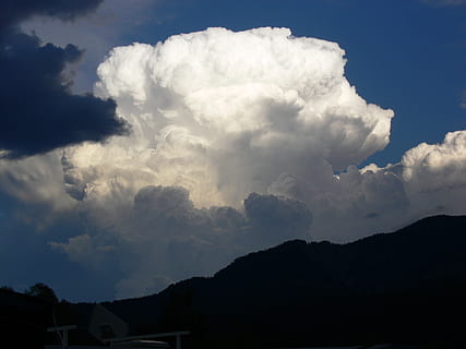cloud, cumulus, thundercloud, white, gigantic, threatening, sky, clouds form, dark clouds, cloud - sky, beauty in nature, scenics - nature, no people, silhouette, nature, architecture, built structure, building exterior, low angle view, tranquil scene, mountain, tranquility, outdoors, building, day, environment, house, non-urban scene, 2K, CC0, public domain, royalty free