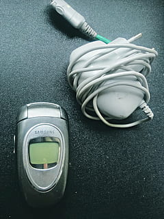 phone, mobile, electronics, samsung, old, charger, technology, close-up, indoors, no people, electricity, still life, equipment, high angle view, cable, connection, fuel and power generation, green color, table, energy efficient, single object, electric plug, environmental conservation, man made, electrical component, control, electrical equipment, power supply, 2K, CC0, public domain, royalty free