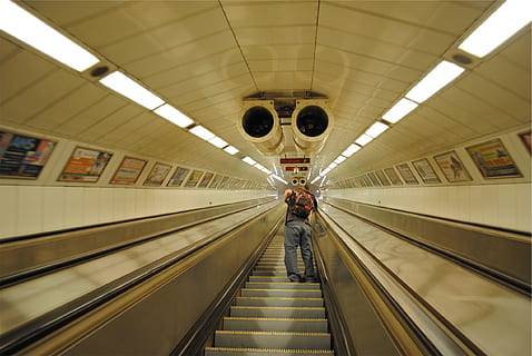 escalator, subway station, guy, backpack, knapsack, indoors, illuminated, transportation, travel, moving walkway, architecture, technology, convenience, ceiling, men, the way forward, direction, modern, real people, railing, futuristic, motion, public transportation, on the move, diminishing perspective, 1080P, CC0, public domain, royalty free