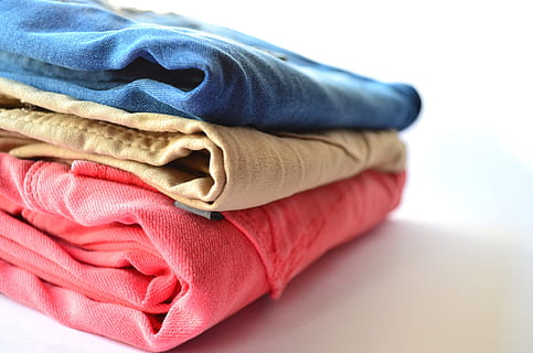 three, red, brown, blue, denim bottomes, clothes, pants, clothing, stack, pink, jeans, trousers, apparel, retail, fabric, laundry, indoors, folded, textile, no people, studio shot, close-up, multi colored, fashion, clean, group of objects, cotton, towel, store, beauty, white background, pink color, garment, softness, 4K, CC0, public domain, royalty free