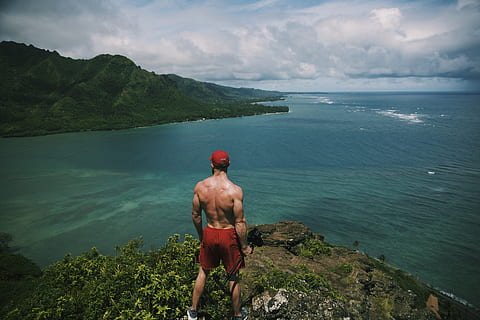 man, standing, cliff, surrounded, water, daytime, red, shorts, high, ground, near, ocean, people, trees, nature, sea, hunk, clouds, sky, mountain, travel, hike, trek, rear view, real people, beauty in nature, scenics, one person, shirtless, leisure activity, lifestyles, scenics - nature, men, holiday, cloud - sky, adventure, day, non-urban scene, trip, outdoors, looking at view, 5K, CC0, public domain, royalty free