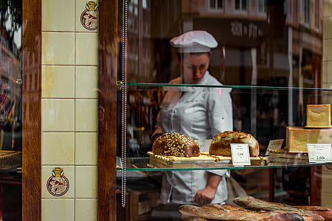 french bakery, woman, white, uniform, standing, inside, bakeshop, bakery, window, baker, bread, seeds, display, shelf, tile, glass, reflection, chef, baguette, pastisserium, le pain, work, store, retail, food and drink, business, occupation, food, small business, baked, baker - occupation, retail display, choice, adult, one person, glass - material, display cabinet, freshness, variation, consumerism, 5K, CC0, public domain, royalty free