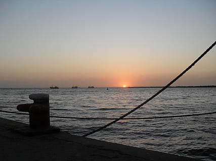 sunset, soft, pink, sky, evening, sea, ocean, bay, quayside, mooring cables, mooring, water, beauty in nature, scenics - nature, tranquility, tranquil scene, clear sky, horizon, no people, nature, copy space, sun, horizon over water, idyllic, orange color, transportation, nautical vessel, outdoors, 2K, CC0, public domain, royalty free