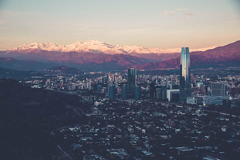 photo, high-rise, buildings, building, structure, sky, infrastructure, window, establishment, hotel, city, urban, architecture, art, glass, roof, clouds, mountains, sunlight, cityscape, building exterior, built structure, sunset, development, no people, skyscraper, mountain, nature, residential district, crowded, crowd, high angle view, mountain range, cloud - sky, travel destinations, scenics - nature, outdoors, office building exterior, townscape, 5K, CC0, public domain, royalty free