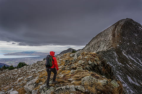 person, wearing, red, hoodie, standing, mountain, peak, grey, cloudy, sky, ridge, rocks, landscape, nature, clouds, people, hiking, climbing, adventure, travel, outdoor, only men, one man only, one person, adults only, adult, rock - object, backpack, cloud - sky, leisure activity, rock, activity, solid, beauty in nature, full length, scenics - nature, recreational pursuit, outdoors, freedom, 5K, CC0, public domain, royalty free