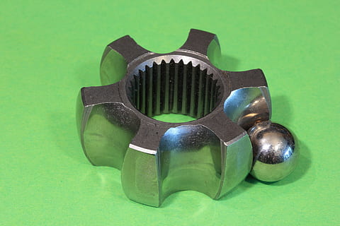 constant, velocity, joint, coupling, automotive, car, drivetrain, race, ball, cv, driveshaft, homokinetic, studio shot, green color, metal, indoors, colored background, close-up, no people, still life, green background, single object, directly above, silver colored, shiny, hand tool, aggression, man made, tool, high angle view, 5K, CC0, public domain, royalty free