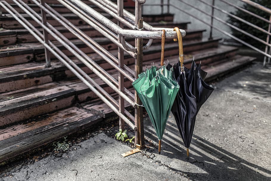 two, green, black, umbrella, stair case, black umbrella, stair, case, objects, urban, lazy, umbrellas, hanging, outdoors, dry, stairs, railing, concrete, storm, shadows, contrast, city, rain, no People, coathanger, day, metal, wood - material, seat, nature, green color, absence, clothing, bench, chair, abandoned, high angle view, architecture, focus on foreground, sunlight, footpath, 5K