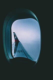 black, red, airplane wing, view, airplane window, sky, daytime, airplane, wing, flight, cloud, window seat, looking out the window, moody, overcast day, overcast, cloudy, mode of transportation, transportation, air vehicle, window, no people, transparent, vehicle interior, glass - material, aircraft wing, shape, geometric shape, circle, travel, nature, close-up, day, outdoors, journey, 5K, CC0, public domain, royalty free