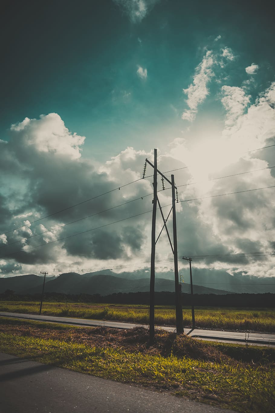 road, landscape, nature, sky, clouds, electricity, energy, environment, grass, high, outdoors, wires, cloud - sky, field, land, no people, technology, day, beauty in nature, scenics - nature, tranquility, rural scene, fuel and power generation, tranquil scene, power supply, 5K