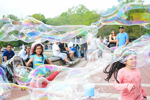 bubbles, children, fun, game, girls, happy, kids, outdoors, play, playing, young, royalty  images, bubble, soap Sud, blowing, bubble Wand, playful, people, group of people, women, men, multi colored, happiness, day, enjoyment, childhood, adult, smiling, standing, group, medium group of people, real people, three quarter length, 5K