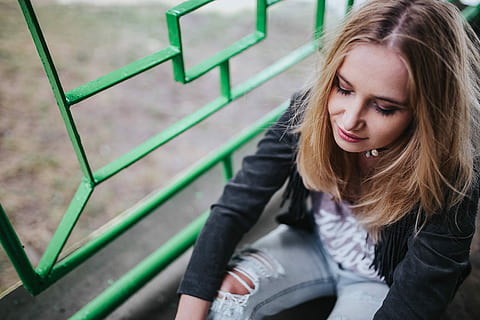 woman, black, jacket, ripped, jeans, green, handrail, Blonde, female, girl, beautiful, rail, pretty, women, people, females, one Person, caucasian Ethnicity, outdoors, young Adult, blond Hair, beauty, adult, sitting, lifestyle, lifestyles, teenager, smiling, long Hair, young Women, looking down, day, front view, hair, real people, hairstyle, looking, leisure activity, casual clothing, focus on foreground, clothing, beautiful woman, contemplation, warm clothing, 4K