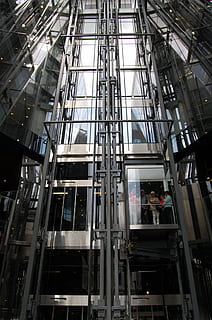 gray, white, elevator, technology, lift, low angle view, built structure, architecture, real people, occupation, working, men, glass - material, building exterior, day, people, two people, outdoors, modern, window, building, transparent, reflection, standing, 1080P, CC0, public domain, royalty free