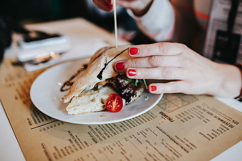 vegetable sandwich, drinks, Tasty, water, coffee, food, glass, delicious, vegatable, vegetarian, vegan, sandwich, plate, people, food And Drink, women, meal, human body part, human hand, one person, newspaper, hand, indoors, nail polish, business, paper, focus on foreground, table, close-up, adult, holding, body part, nail, finger, breakfast, 5K