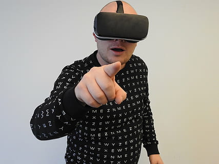 person, wearing, black, crew-neck, long-sleeved, shirt, using, virtual, reality headset, virtual reality, oculus, technology, reality, headset, tech, entertainment, futuristic, device, man, men, virtual Reality Simulator, people, one person, studio shot, front view, standing, indoors, casual clothing, lifestyles, waist up, gesturing, black color, white background, real people, wall - building feature, leisure activity, communication, young adult, copy space, holding, wireless technology, 4K, CC0, public domain, royalty free