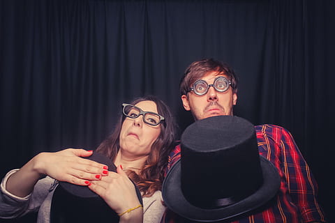 two, woman, making, face, black, curtain, geek, magic, fun, nerd, colorful, play, faces, people, wonder, playing, glasses, two people, eyeglasses, men, indoors, young men, adult, young adult, front view, portrait, headshot, lifestyles, casual clothing, women, leisure activity, couple - relationship, 2K, CC0, public domain, royalty free