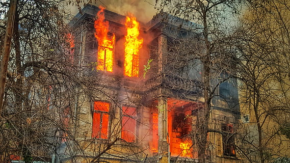 photo, burning, house, trees, blue, gray, concrete, surrounded, leafless trees, fire, flame, orange, fire - natural phenomenon, heat - temperature, tree, nature, accidents and disasters, glowing, bare tree, plant, building exterior, built structure, smoke - physical structure, orange color, architecture, sign, communication, no people, warning sign, outdoors, inferno, 5K, CC0, public domain, royalty free