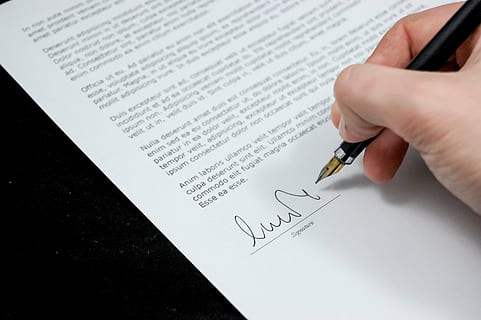 person, holding, signature pen, document, agreement, documents, sign, business, paper, pen, contract, form, human Hand, hand, human body part, writing, text, people, writing instrument, signing, indoors, signature, fountain pen, high angle view, close-up, finger, 2K, CC0, public domain, royalty free