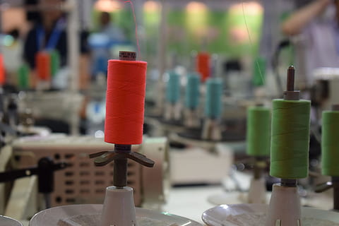 orange, thread, stitching, focus on foreground, close-up, spool, no people, indoors, red, equipment, industry, metal, machinery, workshop, still life, factory, green color, table, business, manufacturing equipment, steel, 5K, CC0, public domain, royalty free