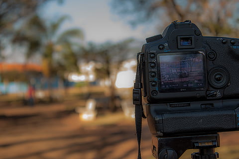 person, using, black, dslr camera, Analogue, blur, camera, dark, display, dlsr, focus, landscape, lens, light, outdoors, park, road, strap, street, technology, travel, zoom, photography themes, camera - photographic equipment, focus on foreground, photographic equipment, close-up, digital camera, no people, tripod, activity, photographing, table, tree, lens - optical instrument, day, beach, selective focus, land, slr camera, filming, digital viewfinder, 4K, CC0, public domain, royalty free