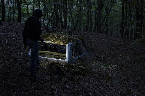abandoned, car, dry leaves, forest, outdoors, person, trees, vehicle, woods, one person, tree, land, full length, real people, lifestyles, plant, standing, nature, woodland, casual clothing, leisure activity, tree trunk, trunk, day, men, adult, 4K, CC0, public domain, royalty free