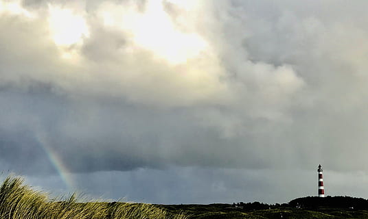 white, red, lighthouse, far, right, rainbow, left, clouds, cloudy, daylight, grass, landscape, light, nature, outdoors, sky, sun, trees, wide angle photography, cloud - sky, tower, built structure, beauty in nature, environment, no people, day, architecture, building exterior, storm, field, land, scenics - nature, plant, pollution, 4K, CC0, public domain, royalty free