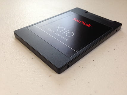 black, sandisk x 110, x110, solid, state drive, top, white, countertop, data storage, ssd, hard drive, memory, sandisk, communication, black color, text, indoors, western script, technology, close-up, no people, high angle view, table, wireless technology, still life, connection, device screen, single object, portable information device, convenience, white color, smart phone, message, 2K, CC0, public domain, royalty free