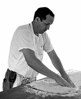 bread, baker, bakery, knead, kneading, dough, bake, black, white, gray, man, apron, one person, men, casual clothing, males, looking, young men, lifestyles, three quarter length, real people, indoors, young adult, front view, looking away, sitting, white background, leisure activity, standing, studio shot, 720P, CC0, public domain, royalty free