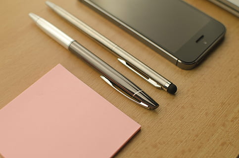 two, twist pens, table, apple, technology, mac, sticky, notes, sticky notes, pen, pink, iphone, black, wood, indoors, education, office, high angle view, wireless technology, no people, close-up, learning, day, connection, communication, still life, group of objects, mobile phone, business, smart phone, two objects, writing instrument, wood - material, portability, note pad, silver colored, 4K, CC0, public domain, royalty free