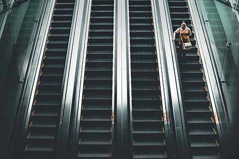 woman, standing, escalator, elevator, steps, stairs, structure, architecture, low angle view, staircase, steps and staircases, built structure, real people, railing, convenience, men, pattern, people, full length, lifestyles, adult, day, building exterior, outdoors, metal, modern, 5K, CC0, public domain, royalty free