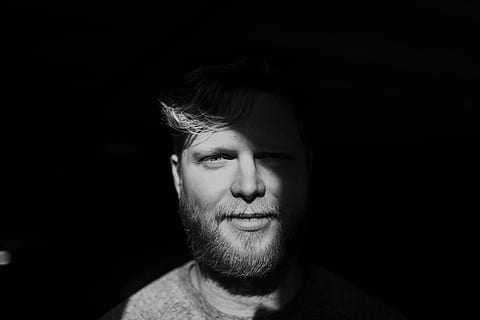 man taking selfie, grayscale photo, man, wearing, crew-neck shirt, face, portrait, dark, male, headshot, beard, facial hair, one person, black background, adult, smiling, indoors, front view, studio shot, close-up, young adult, happiness, looking at camera, lifestyles, mid adult, hairstyle, human face, 5K, CC0, public domain, royalty free
