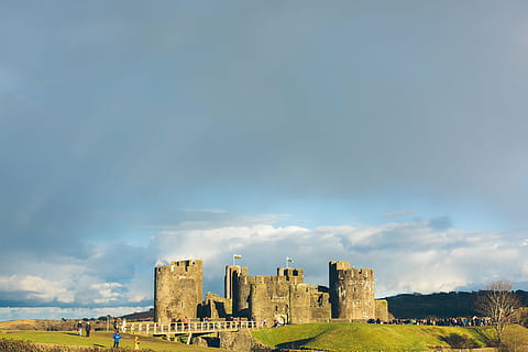 gray concrete castle, gray, concrete, castle, green, grass, pathway, flag, pole, building, structure, people, historic site, mountain, nature, view, landscape, sky, clouds, sunny, summer, sunlight, sunrise, history, architecture, built structure, the past, building exterior, old ruin, ancient, day, cloud - sky, travel destinations, travel, fort, tourism, no people, outdoors, ancient civilization, ruined, archaeology, skyscraper, 1080P