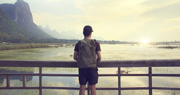 dawn, landscape, mountains, nature, background, backpack, backpacker, clouds, country, edge, green, lake, looking, mountain range, outdoors, person, reflections, sightseeing, sun, sunlight, sunset, trees, view, view deck, water, rear view, one person, railing, beauty in nature, standing, scenics - nature, lifestyles, casual clothing, three quarter length, leisure activity, real people, mountain, young adult, non-urban scene, sky, adult, looking at view, 4K, CC0, public domain, royalty free
