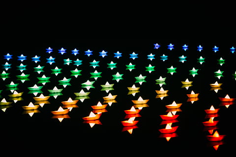 assorted-color lighted boats, assorted-color star string lights, turned, night, stars, lights, lantern, reflection, floating, celebration, black background, large group of objects, illuminated, no people, in a row, studio shot, event, order, burning, multi colored, abundance, fire, decoration, shape, lighting equipment, indoors, 4K, CC0, public domain, royalty free