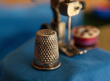 silver-colored thimble, thimble, couture, sewing machine, wire, sewing, tailor, craft, focus on foreground, blue, indoors, close-up, no people, selective focus, equipment, technology, metal, spool, thread, industry, table, arts culture and entertainment, art and craft, textile, creativity, two objects, microphone, silver colored, 2K, CC0, public domain, royalty free
