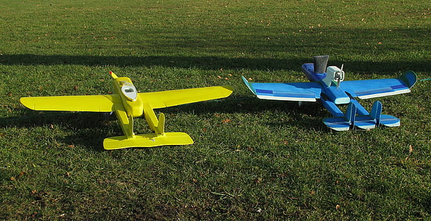 modelo de aeronave, passatempo, modelo, controlado remotamente, voo modelo, grama, plantar, ninguém, natureza, campo, terra, amarelo, cor verde, dia, assento, ausência, visão de alto ângulo, ao ar livre, esvaziar, crescimento, veículo aéreo, gramado, brinquedo, luz solar, parque, 2K, CC0, domínio público, royalty free