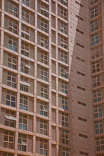 brown, white, concrete, building, high-rise, architecture, windows, pattern, skyscraper, shade, shadow, city, open window, apartments, urban, condo, built structure, window, building exterior, full frame, low angle view, no people, backgrounds, repetition, in a row, day, outdoors, modern, apartment, glass - material, residential district, office building exterior, 5K, CC0, public domain, royalty free