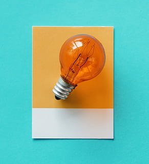 orange, filament light bulb, bulb, paper, electricity, card, colorful, concept, conceptual, creative, creativity, design, electric, electrical, energy, glass, glowing, green, heat, idea, image, innovation, inspiration, invention, isolated, light, light bulb, name, object, power, solution, symbol, technology, think, transparent, tungsten, watt, colored background, indoors, studio shot, no people, blue, still life, blue background, directly above, orange color, table, close-up, pencil, copy space, two objects, eraser, high angle view, single object, pen, rubber, turquoise colored, art and craft equipment, 2K