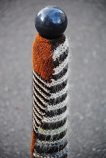knitted, knit, wool, post, ball, close-up, no people, pattern, textile, focus on foreground, day, high angle view, street, art and craft, metal, city, outdoors, single object, textured, gray, softness, creativity, still life, 4K, CC0, public domain, royalty free