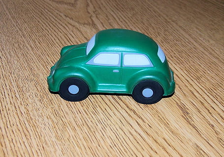 objects, still, life, green, buggy, rubber, green color, car, toy, mode of transportation, toy car, transportation, motor vehicle, childhood, high angle view, plastic, table, wood - material, single object, retro styled, indoors, land vehicle, flooring, technology, 720P, CC0, public domain, royalty free