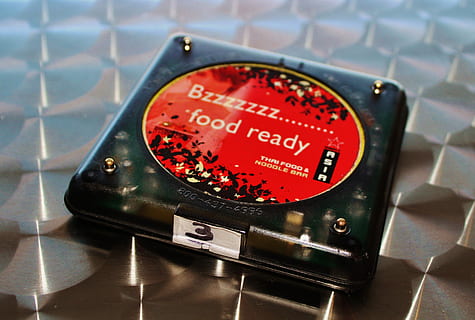 Buzzer, Eating Out, Table, wait, restaurant, red, text, no people, technology, close-up, indoors, communication, number, focus on foreground, connection, sign, metal, instrument of measurement, western script, shape, wireless technology, accuracy, equipment, meter - instrument of measurement, electrical equipment, 4K, CC0, public domain, royalty free