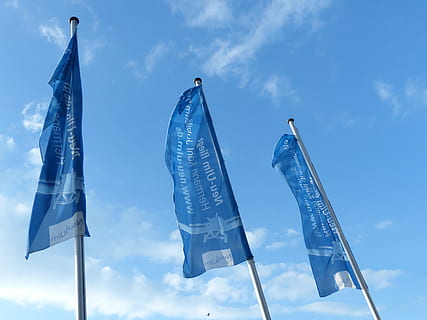 Flags, Blow, Flutter, Sky, blue, flagpoles, hoist, hoisted, cloud - sky, no people, outdoors, day, low angle view, nature, flag, communication, text, pole, three objects, sign, wind, group of objects, hanging, road sign, shape, 4K, CC0, public domain, royalty free