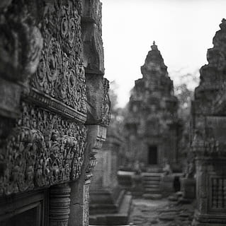 grayscale photo, landmark, architecture, building, infrastructure, structure, establishment, black and white, monochrome, asia, temple - Building, hinduism, buddhism, cultures, religion, spirituality, famous Place, india, ancient, built structure, belief, place of worship, building exterior, focus on foreground, no people, history, the past, travel destinations, craft, day, selective focus, carving - craft product, ancient civilization, ornate, carving, 2K