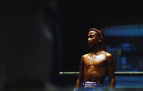 boy, wearing, blue, sport shorts, standing, ring, selective, focus, photography, muay, thai, fighter, inside, people, kid, sport, game, boxing, tournament, athlete, fitness, mma, fighting, one woman only, one person, only women, adult, adults only, indoors, human body part, one young woman only, young adult, waist up, religion, architecture, sculpture, front view, statue, belief, clothing, looking away, hairstyle, contemplation, 2K, CC0, public domain, royalty free
