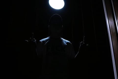 untitled, dark, light, man, hands, arms, streetwear, street, calm, wooden, glowing, lighting, average, middle finger, curse, hat, one person, indoors, men, illuminated, front view, waist up, night, black background, copy space, standing, adult, lighting equipment, performance, portrait, spotlight, light - natural phenomenon, arts culture and entertainment, mid adult, stage light, 5K, CC0, public domain, royalty free