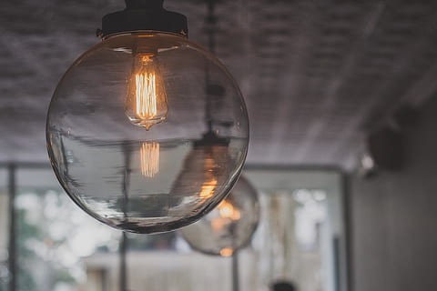 turned, round glass lamp, light, fixture, lighting, interior, bulb, decor, lamp, ceiling, modern, glass - material, focus on foreground, lighting equipment, transparent, illuminated, light bulb, close-up, no people, reflection, filament, electricity, built structure, architecture, hanging, indoors, selective focus, electric light, fuel and power generation, building, electric lamp, 5K, CC0, public domain, royalty free