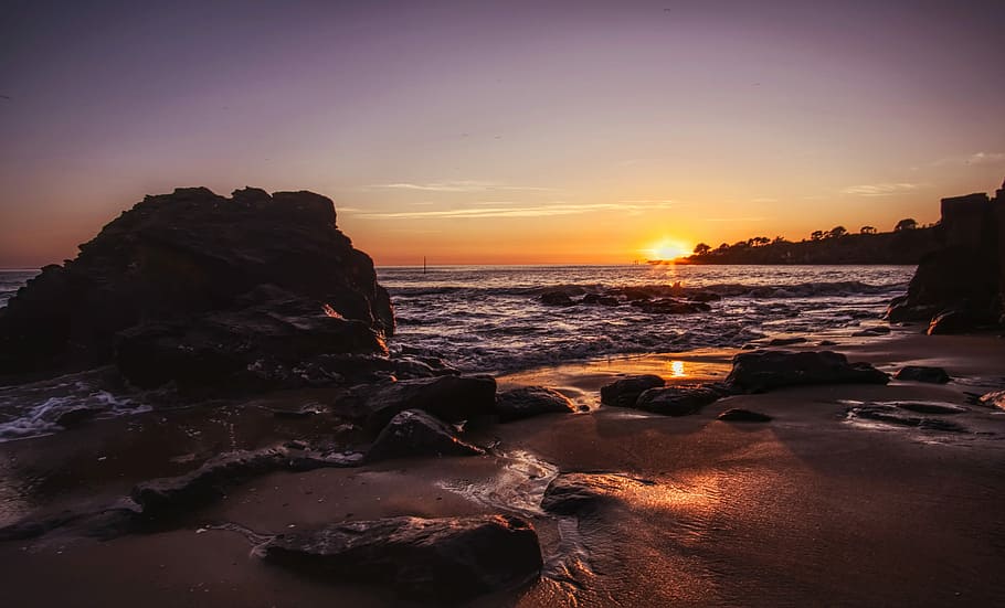solnedgang, strand, solhimmel, sol, hav, himmel, at lyve, sand, natur, aften, lys, tusmørke, vand, klipper, klippe, rock-objekt, scenics - natur, skønhed i naturen, jord, solid, ro, rolig scene, orange farve, horisont, horisont over vand, bevægelse, idyllisk, ingen mennesker, 5K
