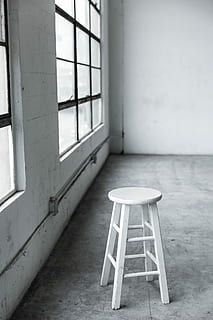 round, white, wooden, stool, closed, window, chair, inside, room, studio, minimal, black, grey, monochromatic, minimalism, wood, concrete, sunlight, moody, simple, basic, texture, simplistic, interior, furniture, indoors, no people, seat, table, empty, day, architecture, absence, abandoned, glass - material, building, still life, wall - building feature, white color, wood - material, flooring, built structure, 5K, CC0, public domain, royalty free