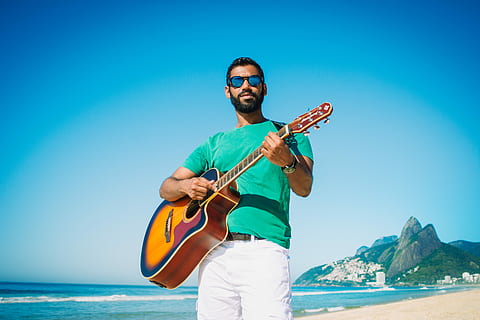 man, playing, guitar, ocean, daytime, acoustic, outdoor, sea, glasses, water, one person, sky, sunglasses, fashion, musical instrument, men, clear sky, blue, nature, leisure activity, adult, holding, string instrument, day, land, music, musician, outdoors, horizon over water, 5K, CC0, public domain, royalty free