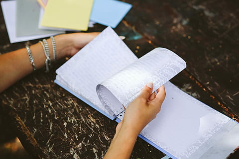 diary, table, Woman reading, woman, book, notebook, hands, reading, memories, journal, memoirs, education, human Hand, people, one Person, learning, student, human body part, adult, one woman only, paper, real people, holding, women, high angle view, lifestyles, hand, indoors, publication, leisure activity, focus on foreground, white color, day, body part, 5K