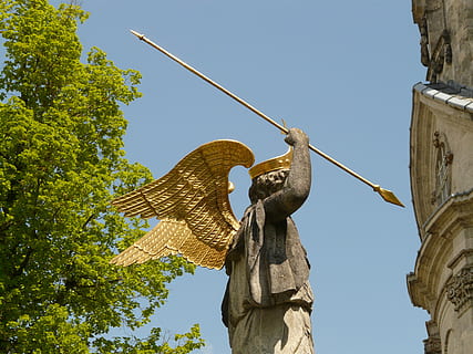 angel, spear, lance, wing, statue, gold, crown, holy, low angle view, art and craft, sculpture, architecture, sky, representation, human representation, nature, built structure, tree, day, creativity, clear sky, no people, plant, craft, building exterior, religion, sunlight, outdoors, 2K, CC0, public domain, royalty free